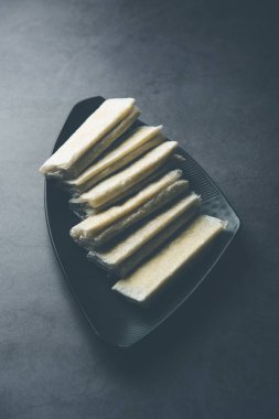 Pootharekulu  is a popular recipe originated from Andhra Pradesh, India.It is a paper-thin sweet or dessert made from rice start/gram flour, jaggery/sugar and clarified butter. Served in a plate.