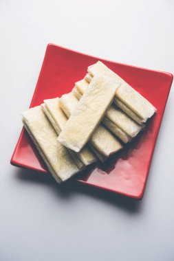 Pootharekulu  is a popular recipe originated from Andhra Pradesh, India.It is a paper-thin sweet or dessert made from rice start/gram flour, jaggery/sugar and clarified butter. Served in a plate.