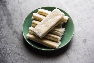 Pootharekulu  is a popular recipe originated from Andhra Pradesh, India.It is a paper-thin sweet or dessert made from rice start/gram flour, jaggery/sugar and clarified butter. Served in a plate.