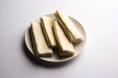 Pootharekulu  is a popular recipe originated from Andhra Pradesh, India.It is a paper-thin sweet or dessert made from rice start/gram flour, jaggery/sugar and clarified butter. Served in a plate.