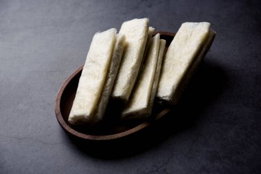 Pootharekulu  is a popular recipe originated from Andhra Pradesh, India.It is a paper-thin sweet or dessert made from rice start/gram flour, jaggery/sugar and clarified butter. Served in a plate.