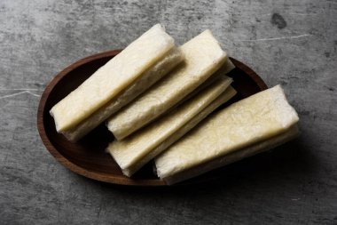 Pootharekulu  is a popular recipe originated from Andhra Pradesh, India.It is a paper-thin sweet or dessert made from rice start/gram flour, jaggery/sugar and clarified butter. Served in a plate.