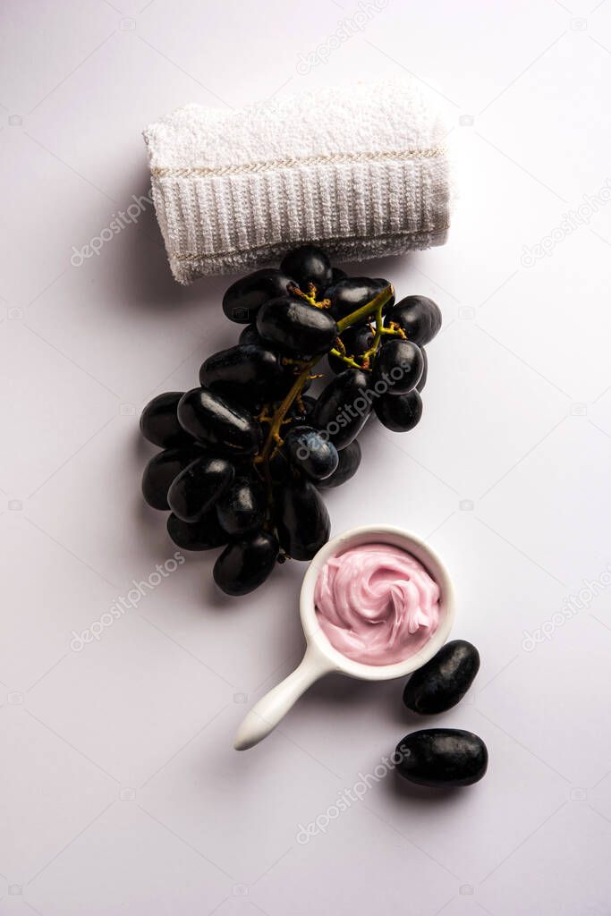 Black grapes, yogurt and honey mix face mask or cream for skin dark spot removal treatment, created using Angoor extract, curd and honey. selective focus