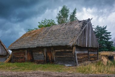 Eski ahşap ev ve üzerinde fırtına bulutları.