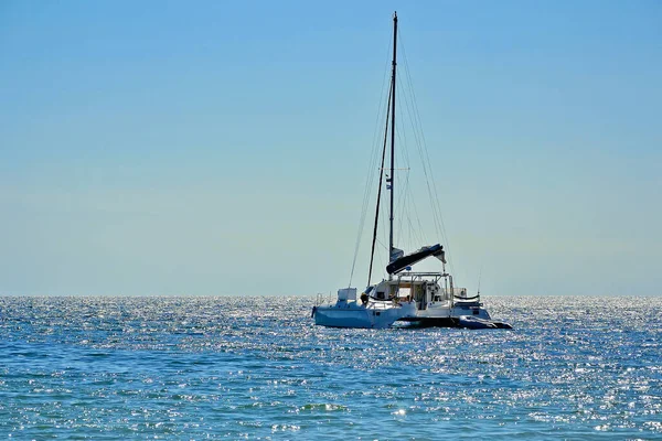 The yacht sails on the sea at sunset.