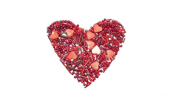 Heart Background from sugar figurines such as confetti, caramel, candy. Ideal symbol of love, st Valentine, romantic  