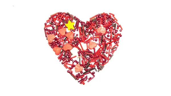 Heart Background from sugar figurines such as confetti, caramel, candy. Ideal symbol of love, st Valentine, romantic  