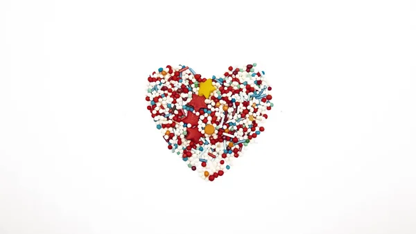 Heart Background from sugar figurines such as confetti, caramel, candy. Ideal symbol of love, st Valentine, romantic  