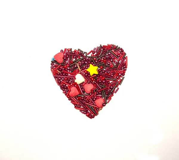Heart Background from sugar figurines such as confetti, caramel, candy. Ideal symbol of love, st Valentine, romantic  