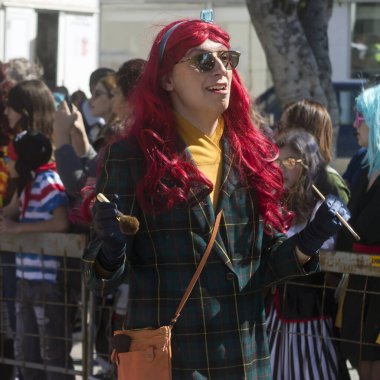 Limassol, Cyprus, March 1st, 2020: A woman in a red wig taking part in the Grand Parade of the Annual Limassol Carnival Festival