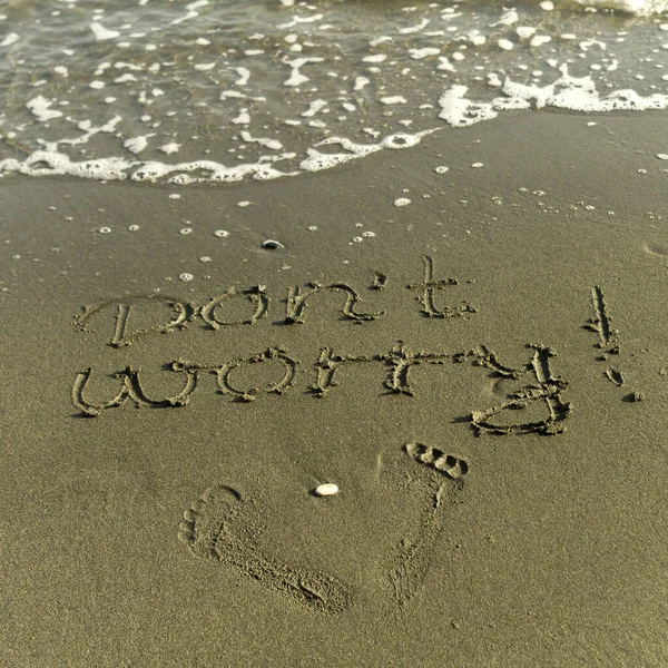 Words Don Worry Two Footprints Wet Sand Sea Beach — стоковое фото