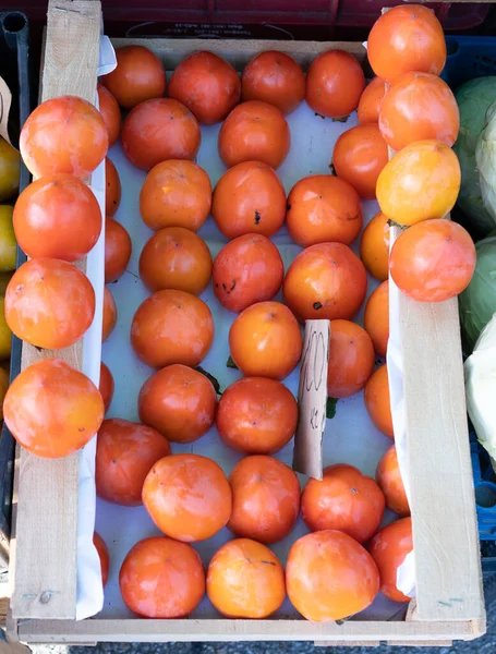 Persimmon in a box for sale — Stock Photo, Image