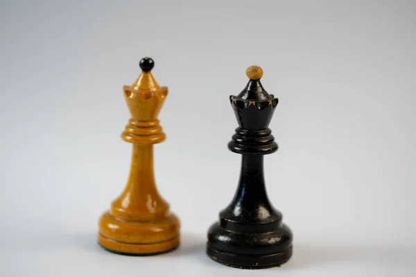 Chess pieces, black queen and white queen