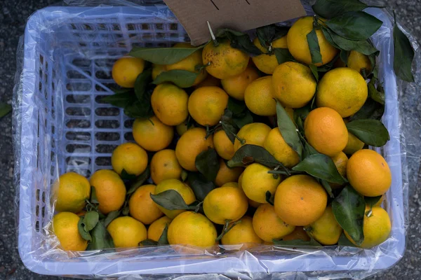 Tangerines on counter for sale.