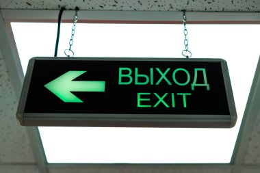 Exit plate, illuminated, mounted under the ceiling