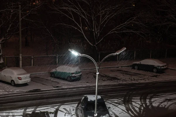 Neve che cade di notte sullo sfondo di un lampione — Foto Stock