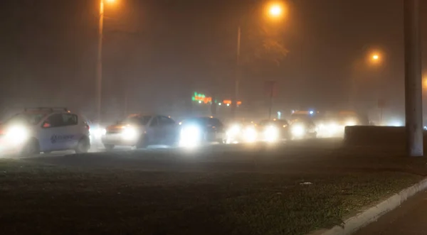 Bilar rider i dimman på natten — Stockfoto