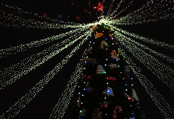 Weihnachtsbaum in der Nacht mit Spielzeug und Neonlichtern geschmückt — Stockfoto