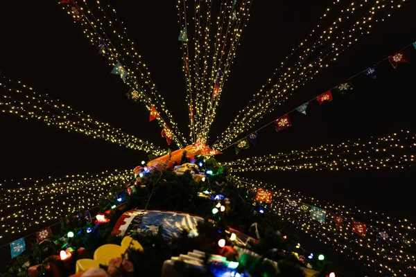 Christmas tree decorated with toys and lights — Stock Photo, Image