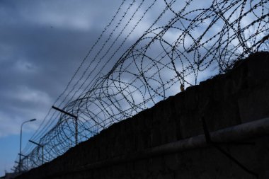 Barbed wire along the fence
