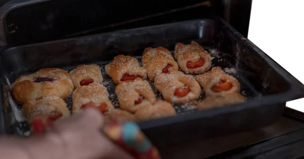 Sweet pastries on a baking sheet from the oven