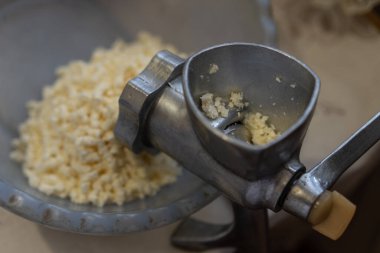 Elle kıyma makinesi peynir öğütür.