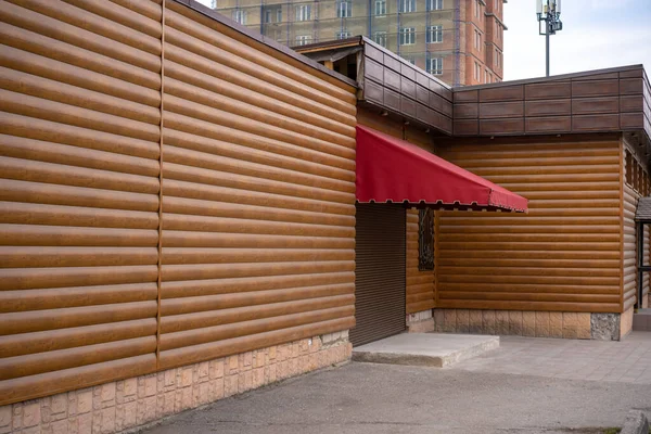 Shop with a canopy and wood wall lining