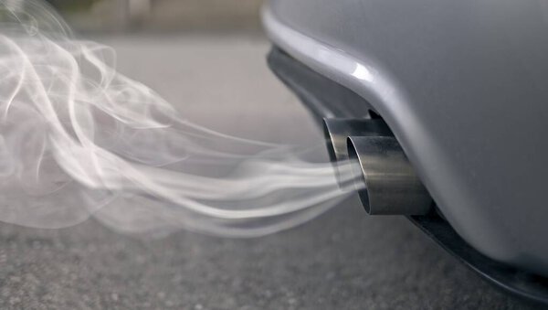 Smoky exhaust pipes from a starting diesel car.