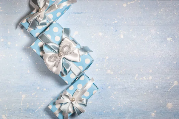 Blue gift boxes on light blue textured background