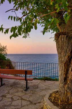 Yunanistan 'ın Lefkada adasının batı kıyısındaki Agios Nikitas köyünde güzel bir günbatımı.