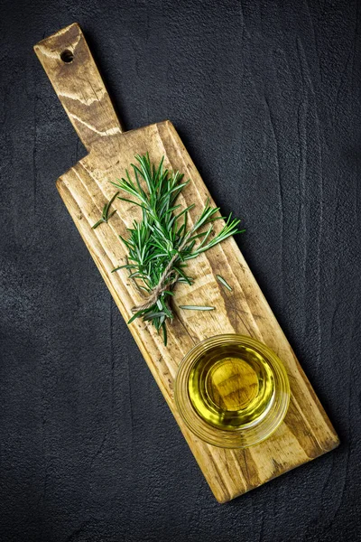 Fresh Rosemary Branches Olive Oil Black Stone Table Top View — Stock Photo, Image