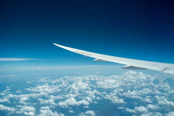 Aircraft flying above the clound and blue sky. Nice view from the airplane window.