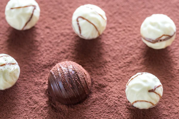 Chocolate candies on cocoa background — Stock Photo, Image