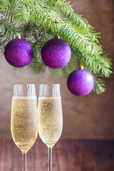 Two glasses of champagne with Christmas tree branch — Stock Photo, Image