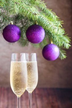 İki bardak şampanya ile Noel ağacı dalı