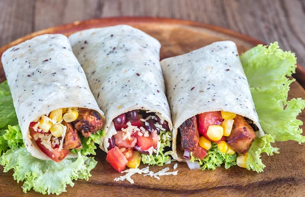 Three chicken burritos on the wooden board — Stock Photo, Image