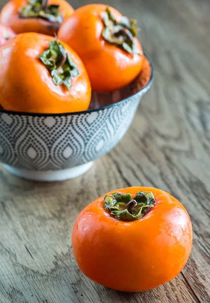 Bowl of fresh persimmons — Stock Photo, Image