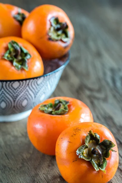 Bowl of fresh persimmons — Stock Photo, Image