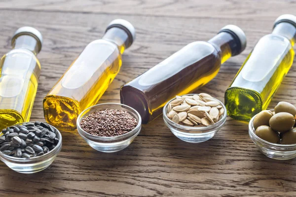 Bottles with different kinds of vegetable oil — Stock Photo, Image