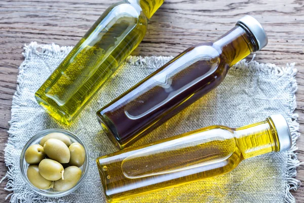 Bottles with different kinds of olive oil — Stock Photo, Image
