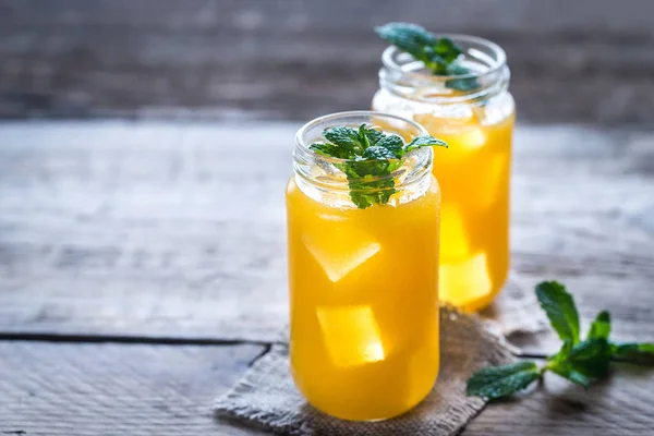 Glass jars of mango juice — Stock Photo, Image