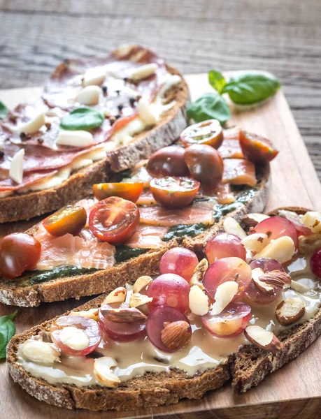 Bruschetta with different toppings — Stock Photo, Image