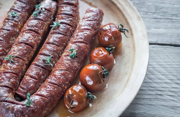 Chorizo asado con tomates cherry —  Fotos de Stock