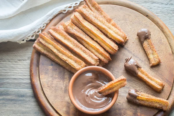 Churros - famous Spanish dessert with chocolate sauce — Stock Photo, Image