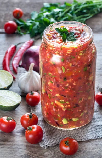 Jar of salsa with ingredients — Stock Photo, Image
