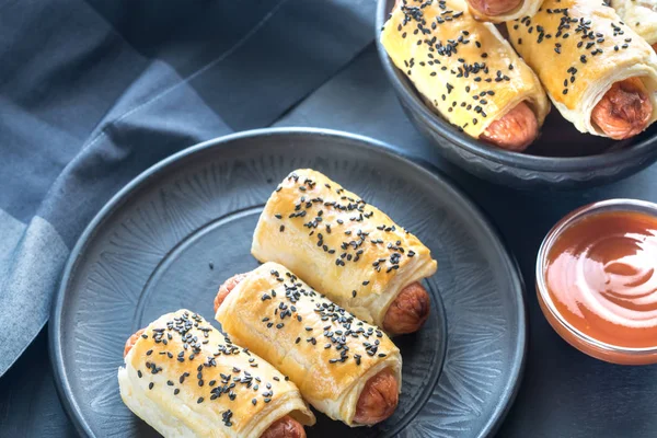 Sausage rolls on the plate — Stock Photo, Image