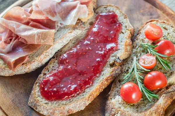 Bruschetta with different toppings — Stock Photo, Image