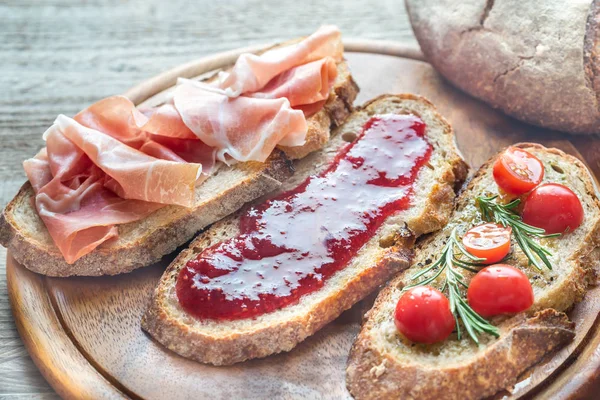 Bruschetta with different toppings — Stock Photo, Image