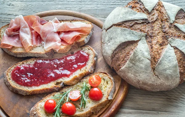 Bruschetta with different toppings — Stock Photo, Image