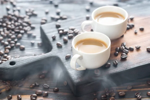 Two cups of coffee with coffee beans — Stock Photo, Image